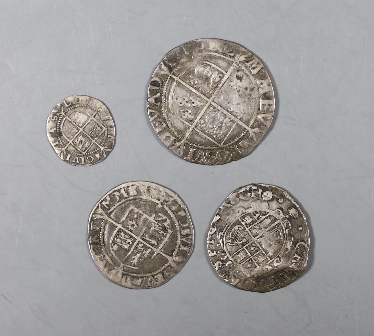 British coins, Elizabeth I shilling, sixpence and threepence and a James I shilling.